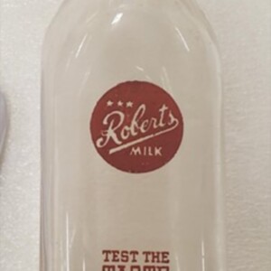 This is the Roberts Milk bottle from the Durham Museums archives. It is a glass bottle with a “polyglazed” Roberts Milk logo on the front.